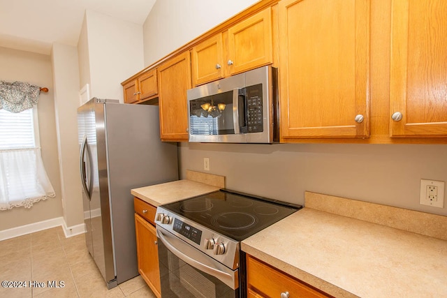 kitchen featuring appliances with stainless steel finishes and light tile patterned floors