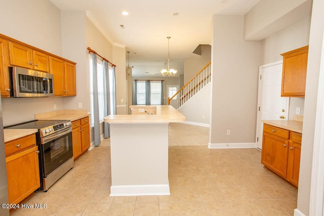 kitchen with a kitchen island, a notable chandelier, decorative light fixtures, light tile patterned floors, and appliances with stainless steel finishes