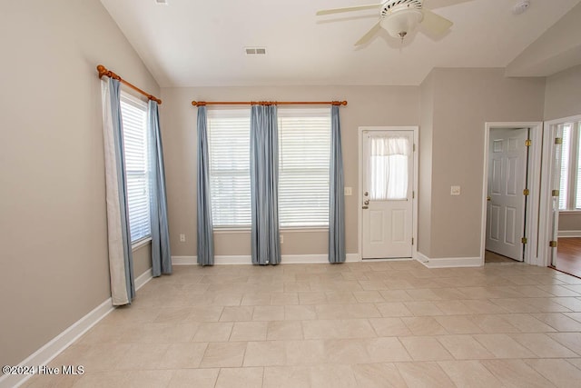 foyer entrance featuring lofted ceiling, light tile patterned flooring, and ceiling fan