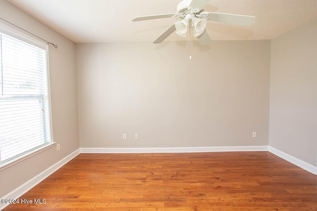 spare room featuring light hardwood / wood-style flooring, a textured ceiling, and ceiling fan