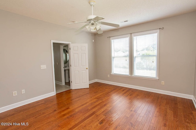 unfurnished room featuring a textured ceiling, wood-type flooring, and ceiling fan