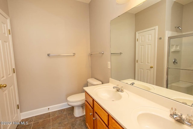 bathroom featuring vanity, toilet, and walk in shower