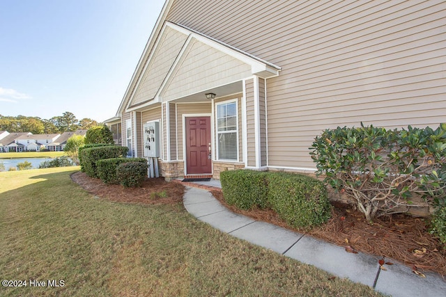 entrance to property with a lawn