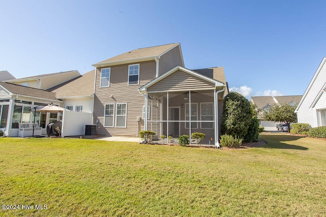 rear view of house featuring a yard, a patio area, central AC unit, and a sunroom