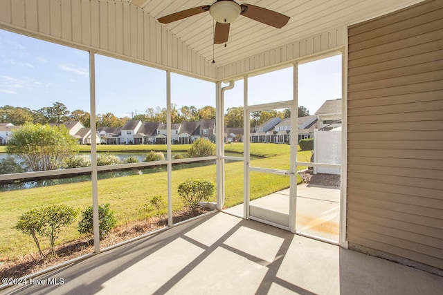 sunroom / solarium with a water view, ceiling fan, vaulted ceiling, and wood ceiling