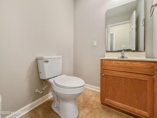 bathroom with vanity, tile patterned floors, and toilet