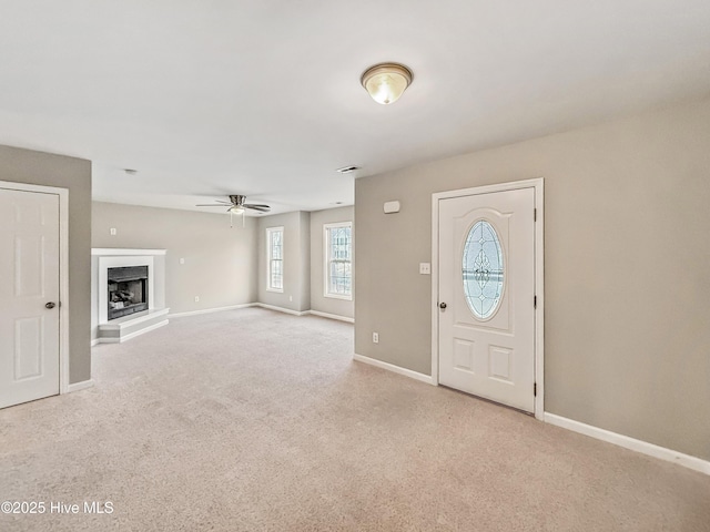 carpeted entryway featuring ceiling fan