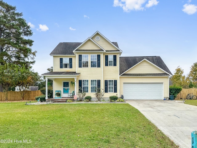 view of front facade with covered porch, a front yard, and a garage