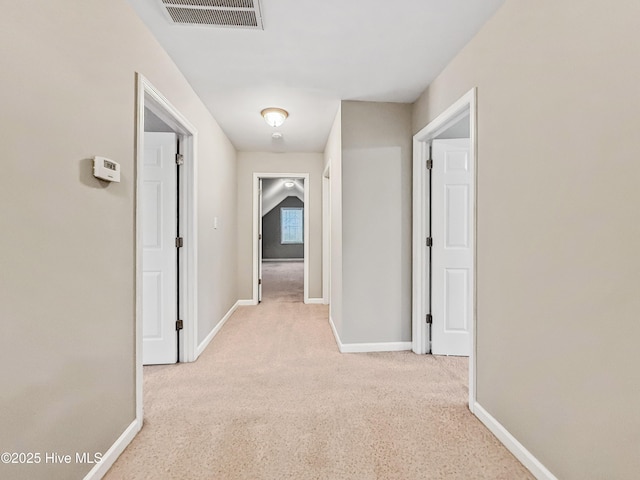 hallway featuring light carpet