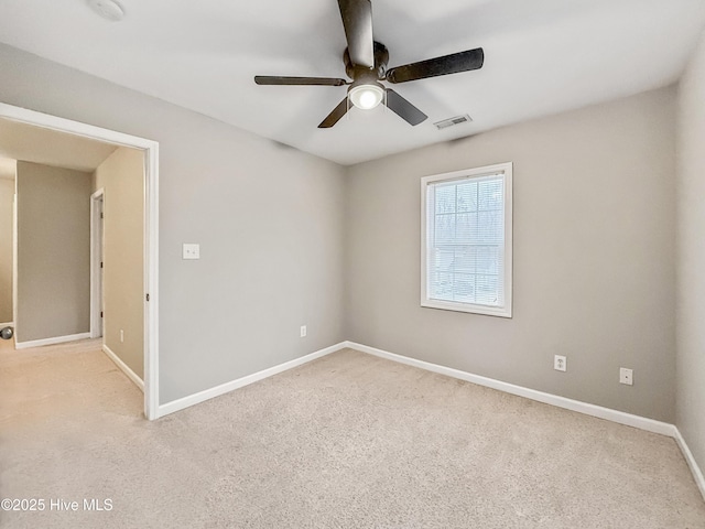 unfurnished room with light carpet and ceiling fan