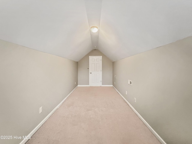 bonus room with carpet floors and vaulted ceiling