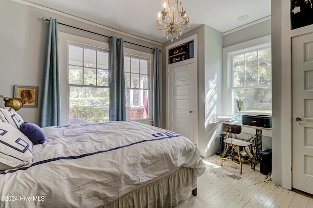 bedroom featuring a chandelier and light wood-type flooring