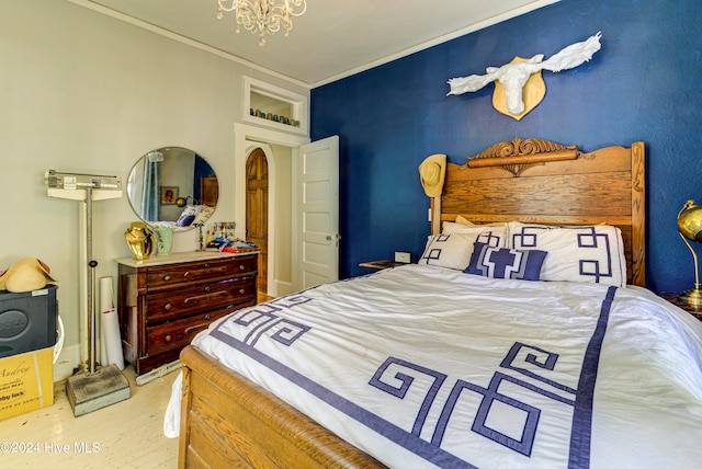 bedroom featuring light hardwood / wood-style floors and a chandelier