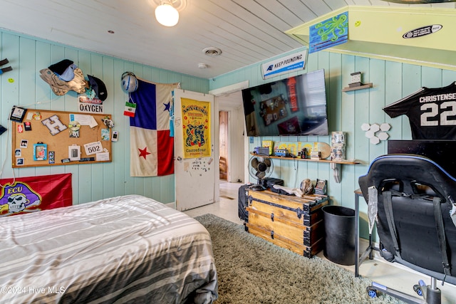 bedroom with wood walls