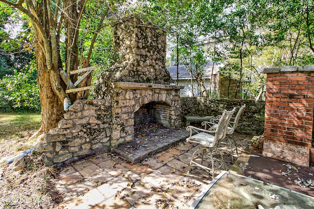 view of patio with an outdoor stone fireplace