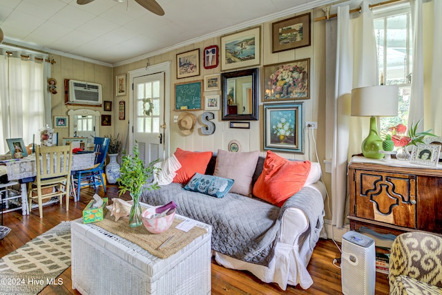 living room featuring ornamental molding, dark hardwood / wood-style floors, a wall mounted AC, and ceiling fan