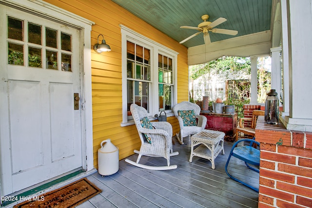 deck featuring covered porch and ceiling fan