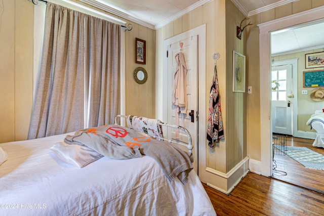 bedroom featuring crown molding and hardwood / wood-style flooring