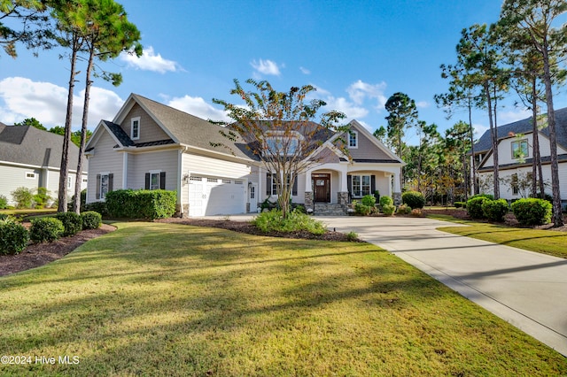 view of front of house featuring a garage and a front lawn