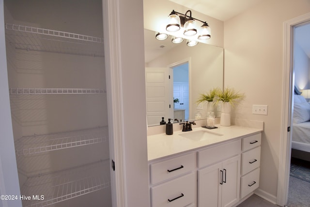 bathroom with vanity and ensuite bath