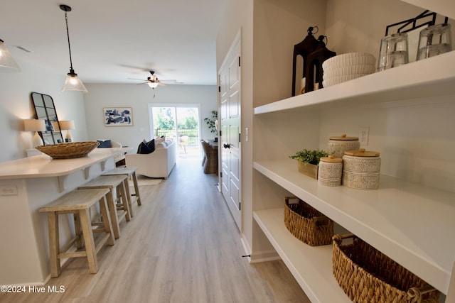 hallway with light wood finished floors and baseboards