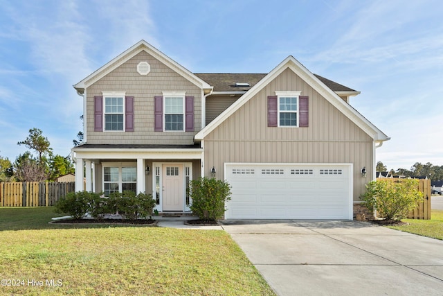 view of front of home with a front lawn, a garage, and covered porch