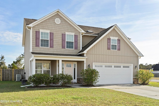 view of front of home featuring a garage, central air condition unit, and a front yard