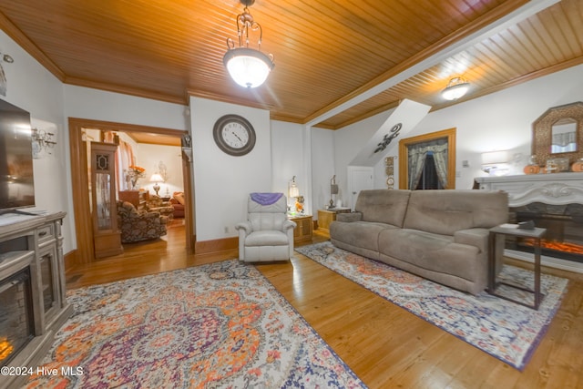 living room featuring ornamental molding, light hardwood / wood-style floors, and wood ceiling