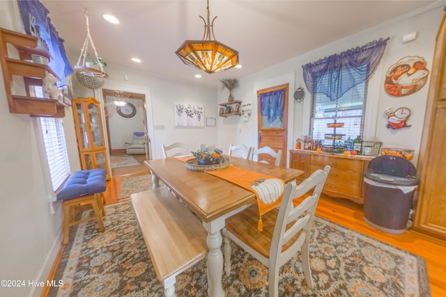 dining room featuring ornamental molding and light hardwood / wood-style flooring