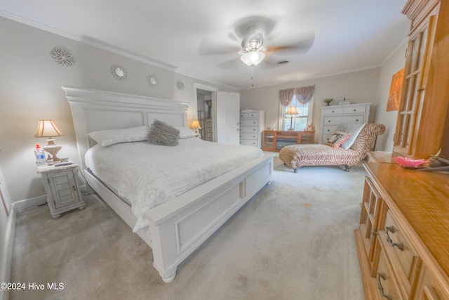 carpeted bedroom with ceiling fan and crown molding