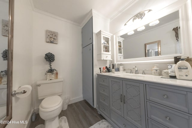 bathroom featuring hardwood / wood-style floors, crown molding, vanity, and toilet