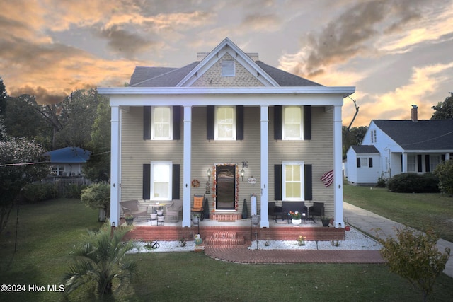 view of front of home with a yard and covered porch