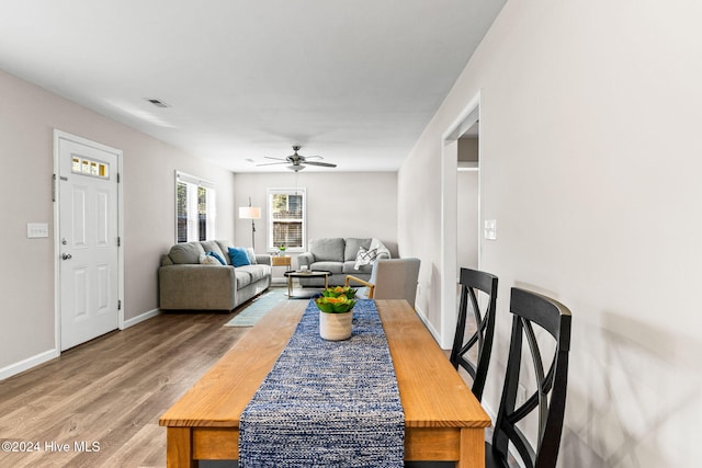 dining area with ceiling fan and hardwood / wood-style floors