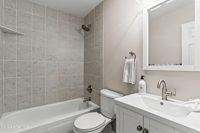 full bathroom with toilet, vanity, and tiled shower / bath combo