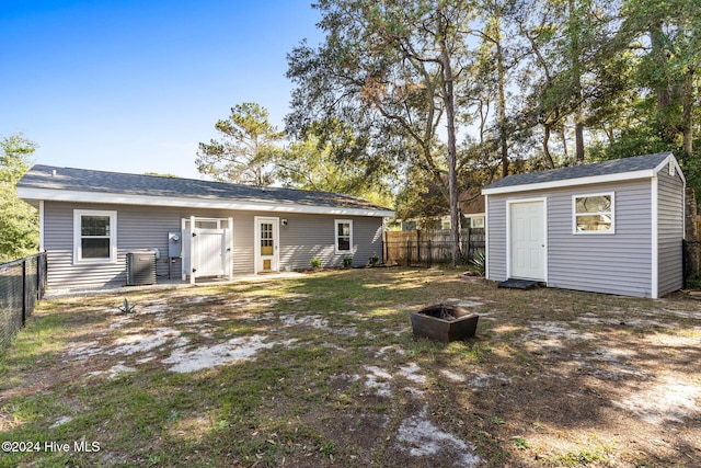 rear view of property with an outdoor structure