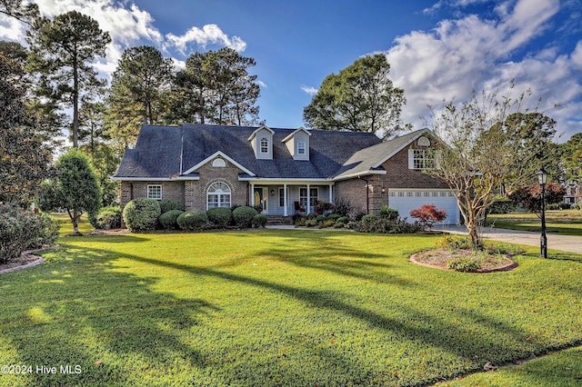 cape cod house featuring a front yard and covered porch