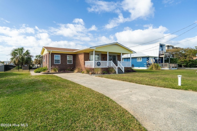 view of front of home with a front yard and covered porch