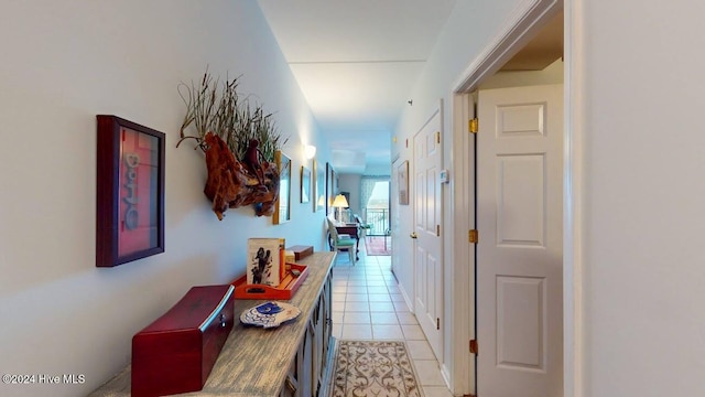 hall with light tile patterned floors