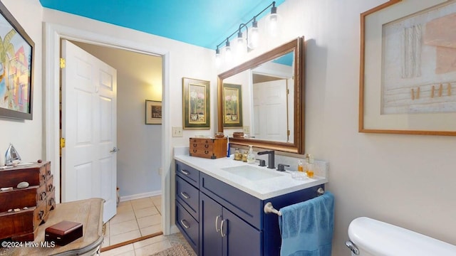 bathroom with vanity, toilet, and tile patterned floors