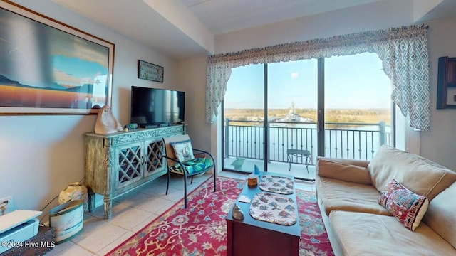 living room with sink, ceiling fan, and light tile patterned flooring