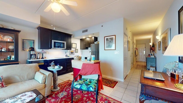 tiled living room with ceiling fan