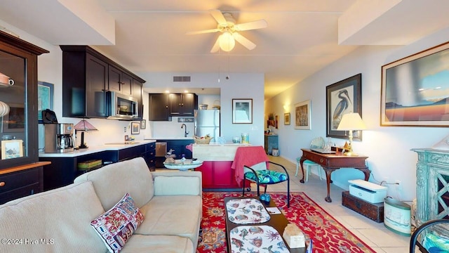 tiled living room featuring sink and ceiling fan