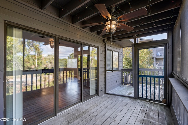 unfurnished sunroom with a healthy amount of sunlight and ceiling fan