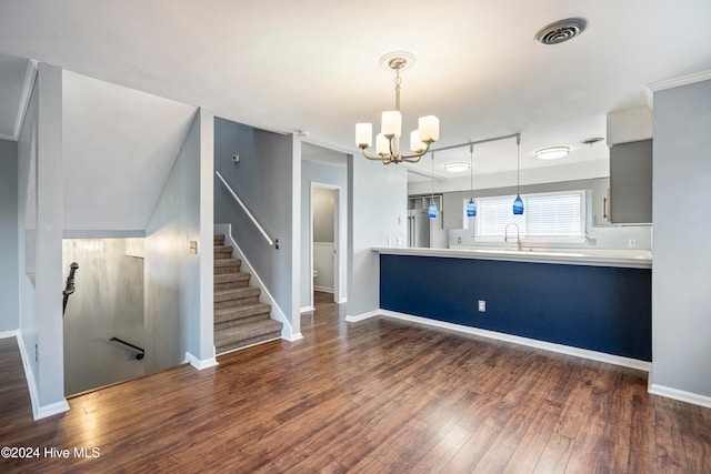 interior space featuring dark wood-type flooring, a notable chandelier, and decorative light fixtures