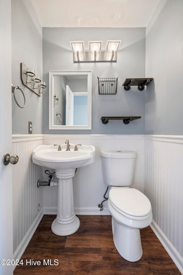 bathroom featuring toilet, hardwood / wood-style flooring, and sink