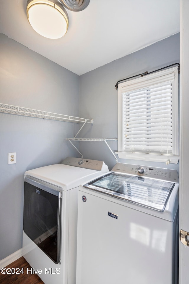 washroom featuring washer and dryer and dark wood-type flooring