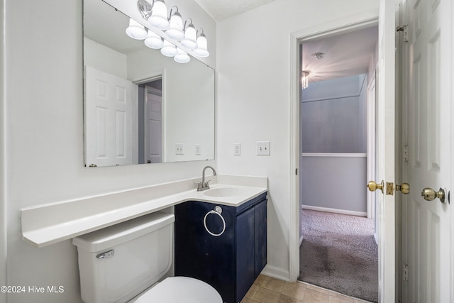 bathroom featuring vanity, toilet, and tile patterned flooring