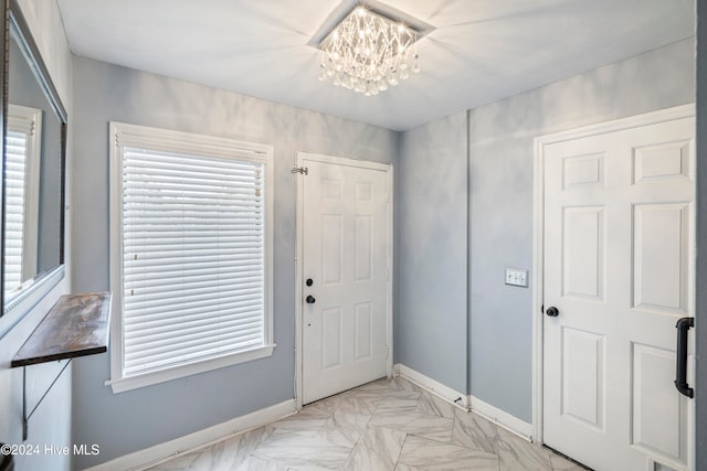 foyer entrance with a wealth of natural light and a chandelier