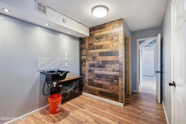 hallway with hardwood / wood-style floors