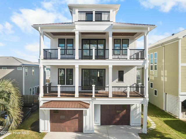 rear view of property featuring a garage and a balcony